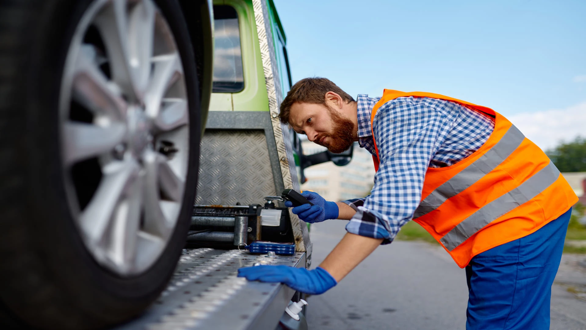 Professional tow truck operator safely loading a vehicle using skilled heavy-duty towing in Vermont